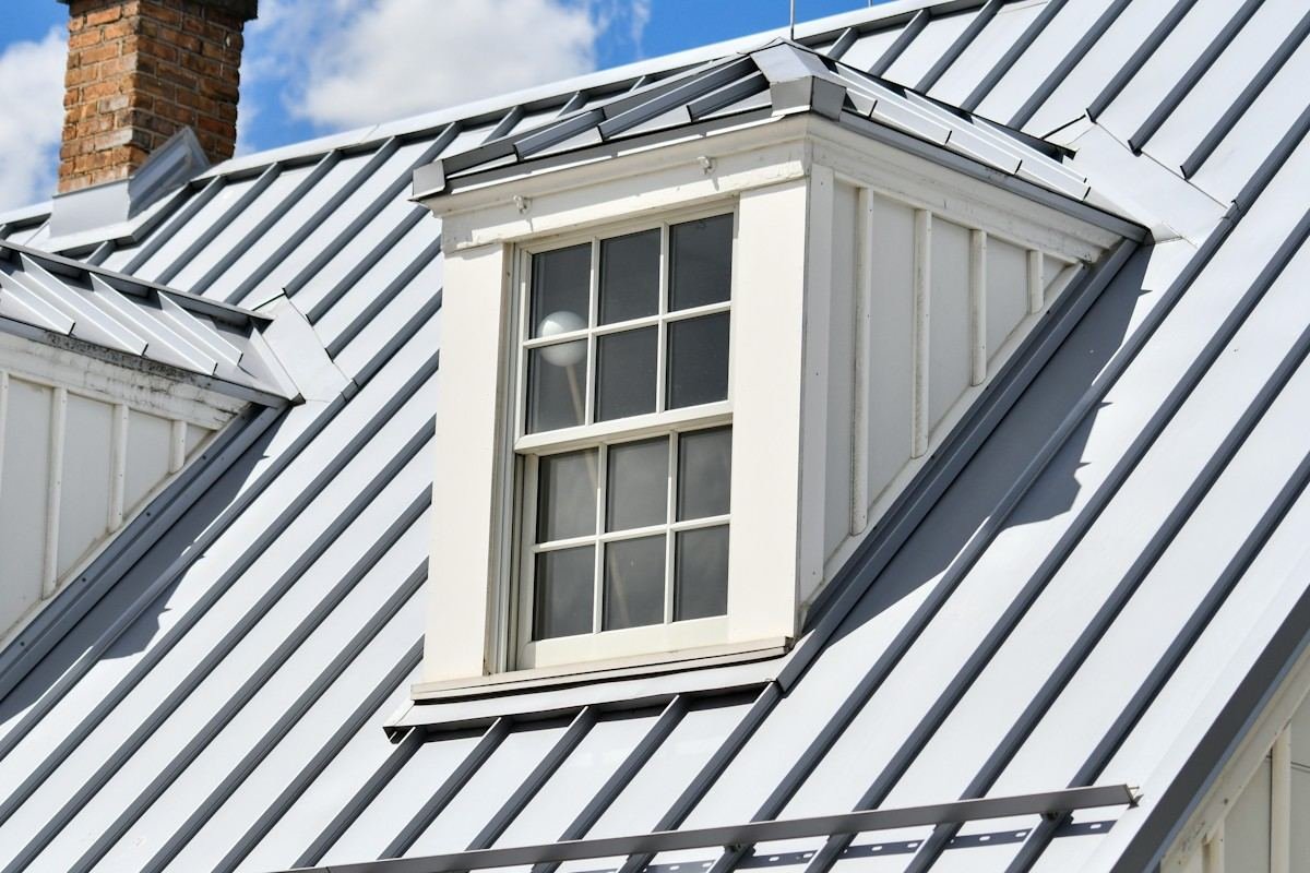 Close view of a dormer set into a standing-seam metal roof